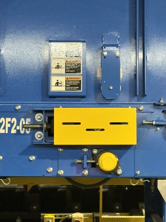 Blue machine panel with yellow components resembling a face, shared in a group showcasing random objects that look like faces.