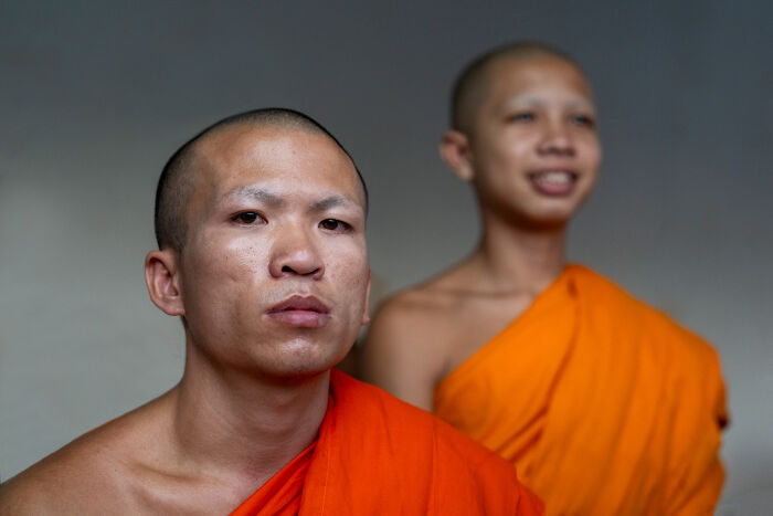 Two monks wearing traditional orange robes, capturing the beauty of cultures through photography in diverse countries.