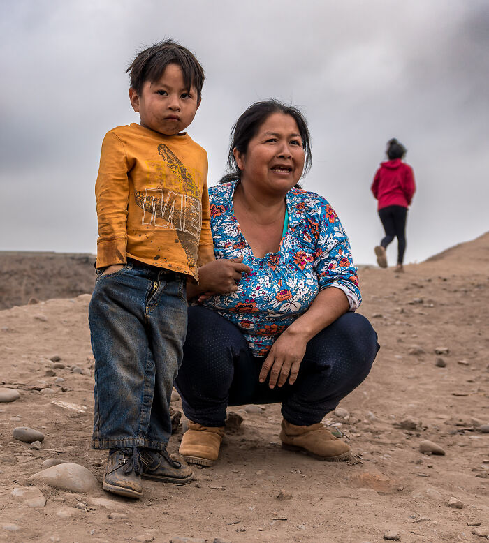 Woman and child outdoors on a dirt path captured by a photographer traveling to over 50 countries to showcase cultural beauty.