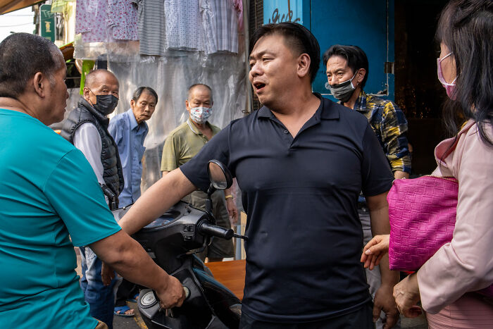 A street scene capturing diverse people interacting, illustrating the beauty of cultures through vibrant daily life moments.