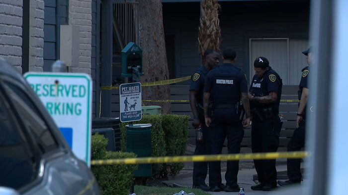 Police officers outside house investigating after hungry and thirsty toddlers led police to heartbreaking scene.