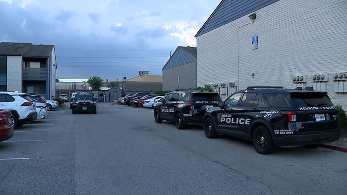 Houston police vehicles parked outside an apartment complex responding to a case involving hungry and thirsty toddlers.