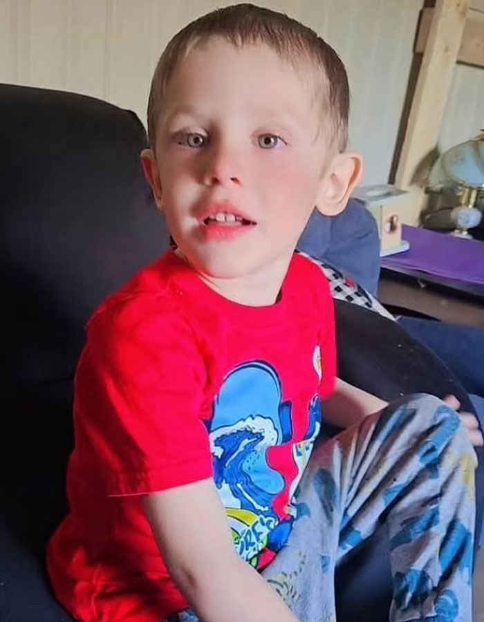 Young boy wearing a red shirt sitting indoors, related to polygraph results made public for parents of missing kids.