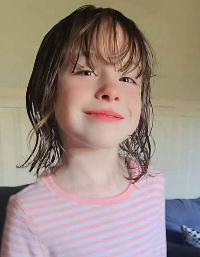Young girl with wet hair wearing a pink striped shirt, related to polygraph results for kids disappeared without a trace.