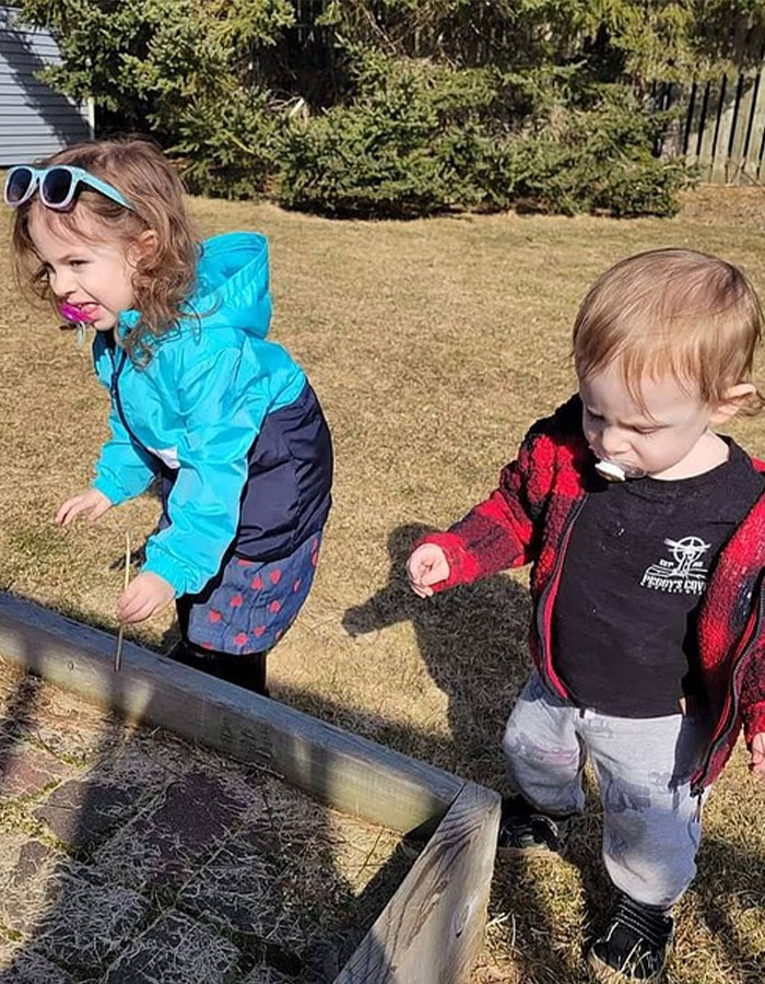 Two young kids outside in a yard, highlighting the context of polygraph results made public for parents.
