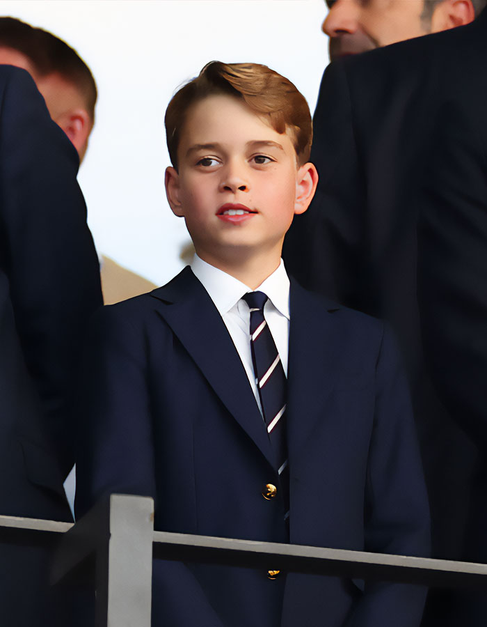 Prince George dressed in a navy blazer and striped tie, spotlighted as the future king during a public event. Prince George dressed in a navy blazer and striped tie, spotlighted as the future king during a public event.