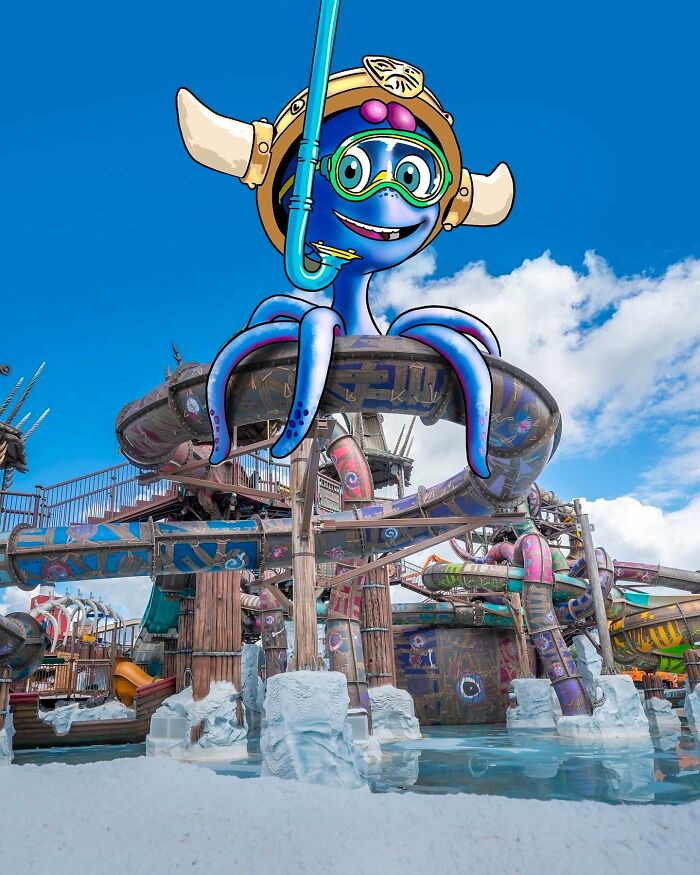 Cartoon octopus with snorkeling gear added to a colorful waterslide in a reimagined landscape artwork.