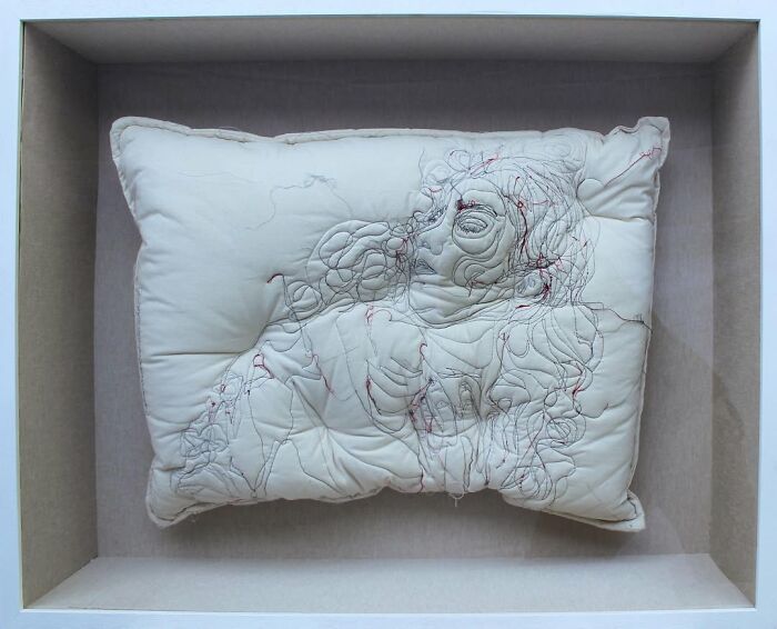 Embroidered pillow featuring a detailed stitched design of a woman, showcasing dreamy embroidered pillows by Maryam Ashkanian.