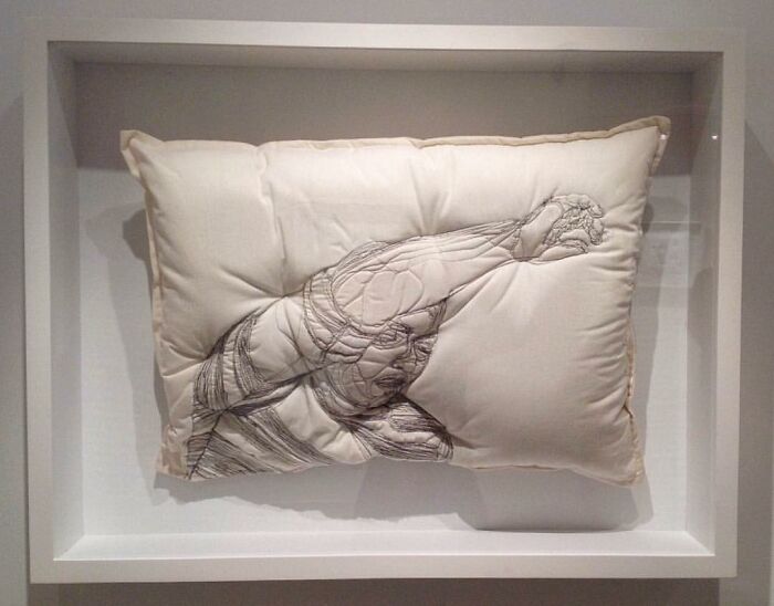 Embroidered pillow artwork by Maryam Ashkanian featuring a detailed figure capturing the beauty of sleep.
