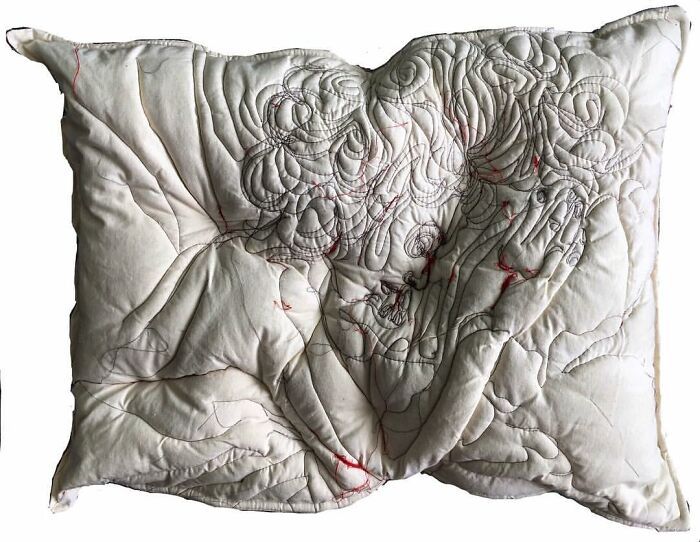 Embroidered pillow featuring intricate thread art depicting a dreamy, emotional figure capturing the beauty of sleep.