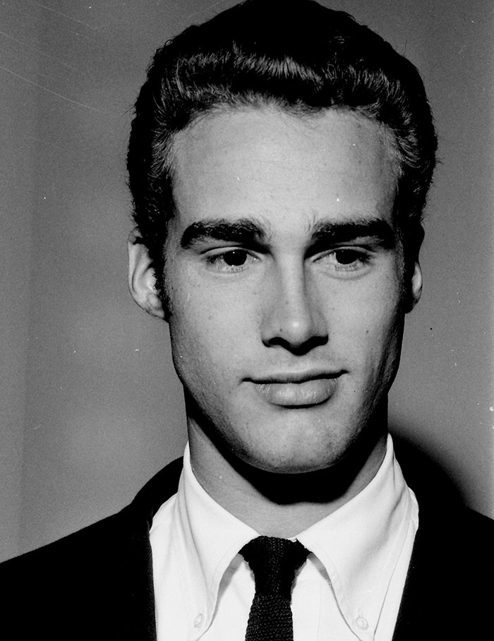 Black and white portrait of a young celebrity with dark hair, wearing a suit and tie, representing unsolved disappearances.