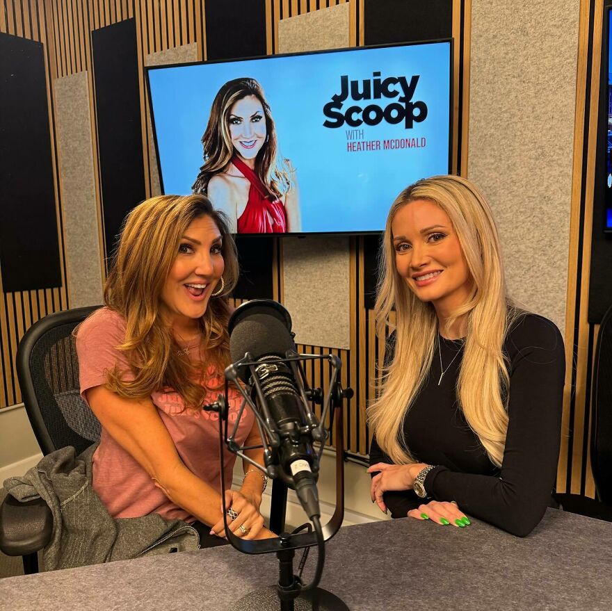 Two women smiling in a podcast studio with a microphone, discussing Stephen Hawking Epstein Island allegations.