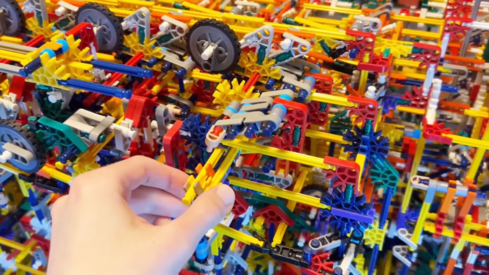 Hand adjusting colorful K’Nex pieces in a complex fully functional 8-bit computer model built from K’Nex parts. Hand adjusting colorful K’Nex pieces in a complex fully functional 8-bit computer model built from K’Nex parts.