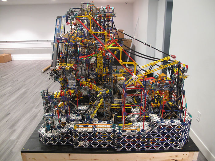 Complex 8-bit computer model made entirely from colorful K’Nex pieces displayed on a black platform indoors. Complex 8-bit computer model made entirely from colorful K’Nex pieces displayed on a black platform indoors.