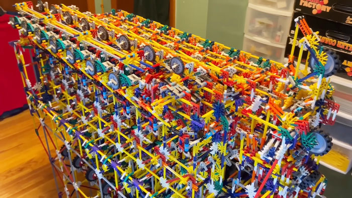 Intricate 8-bit computer model built entirely from colorful K’Nex pieces displayed on a wooden floor indoors. Intricate 8-bit computer model built entirely from colorful K’Nex pieces displayed on a wooden floor indoors.