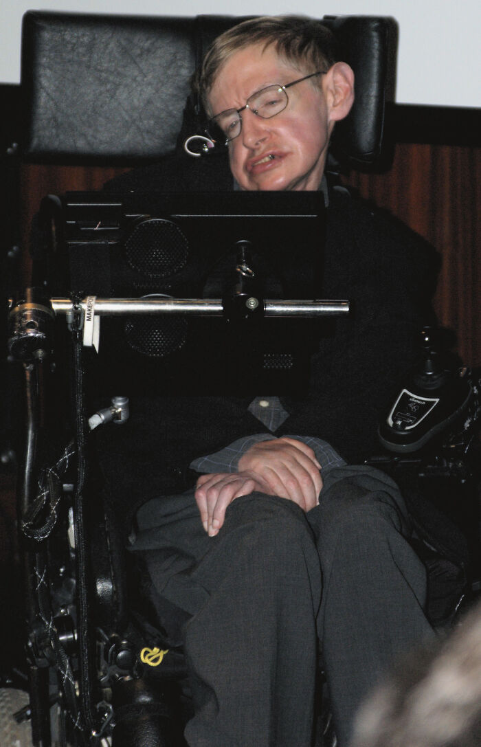 Person in a wheelchair using assistive technology, captured in a candid moment related to savage roasts and comebacks.