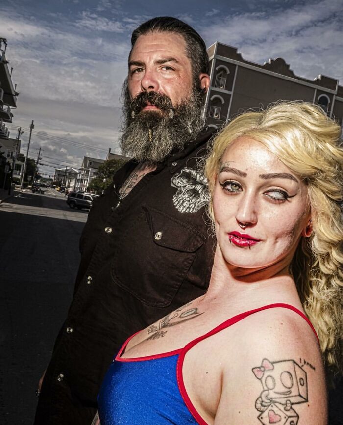 Bearded man and tattooed woman posing outdoors in a powerful street photo capturing the beauty of everyday life.