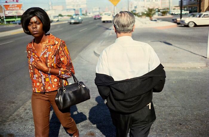 Woman in patterned shirt and man with jacket on street, capturing powerful street photos of everyday life moments.