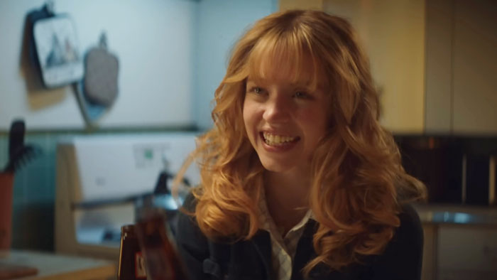 Sydney Sweeney smiling in a scene, highlighting her new movie flopping amid American Eagle backlash news.