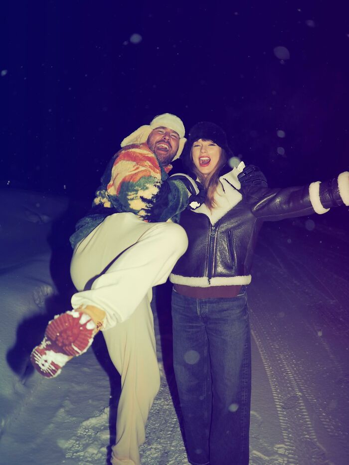 Taylor Swift and a man smiling and posing outdoors at night in winter clothes with snow on the ground, music countdown theme.