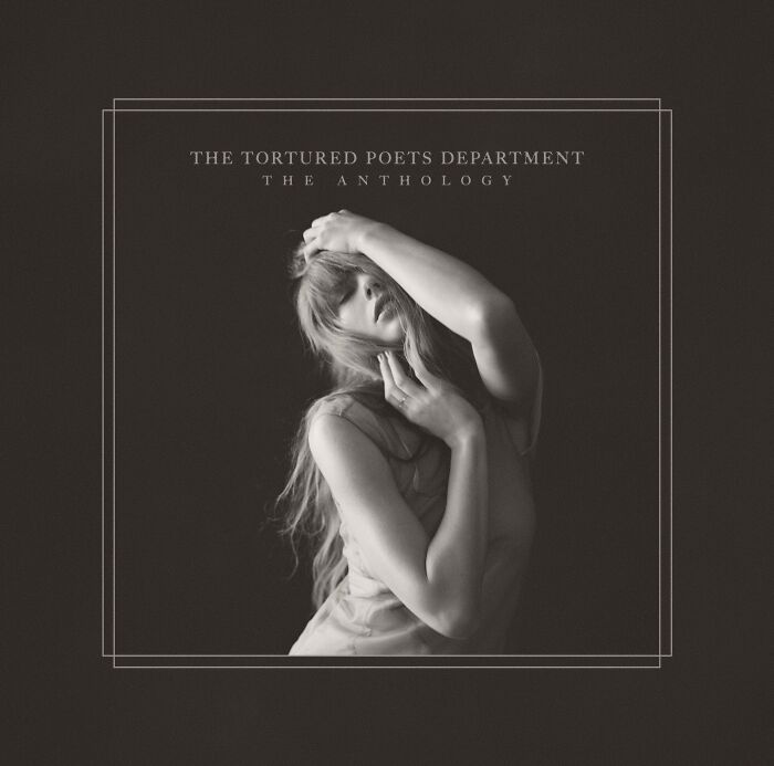 Taylor Swift, the queen of music, in a black and white artistic pose on album cover The Tortured Poets Department anthology.