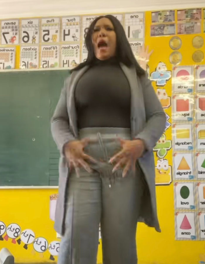 Teacher performing the viral private parts song for first grade kids in a colorful classroom with educational posters. Teacher performing the viral private parts song for first grade kids in a colorful classroom with educational posters.