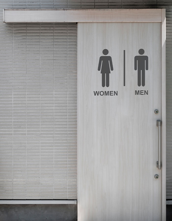 Restroom door with women and men signs highlighting gender identification in a public setting related to gender proof controversy.