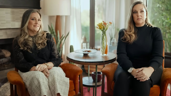 Two women sitting in armchairs in a living room setting, discussing the impact of The Biggest Loser and PTSD.