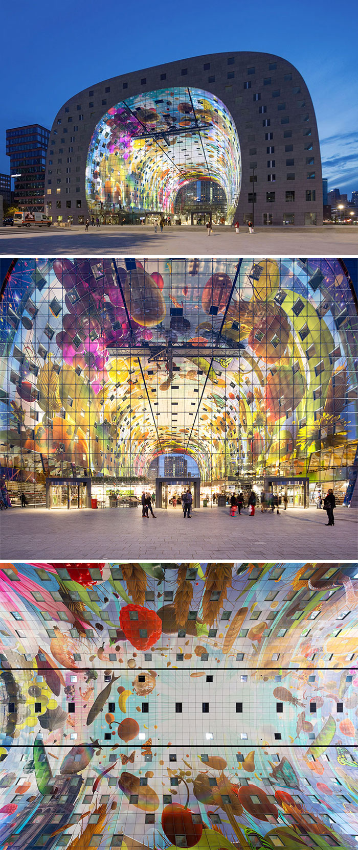 Colorful street art mural covering the curved interior and exterior walls of a modern urban building at dusk.