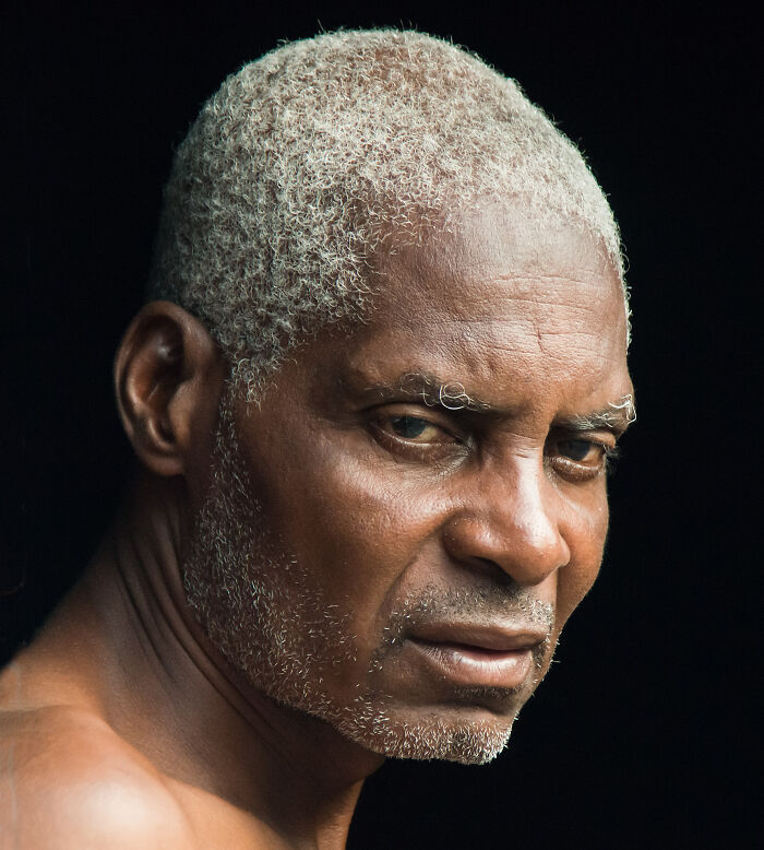 Close-up portrait of an elderly man with gray hair and beard, capturing cultural beauty in a detailed photograph.