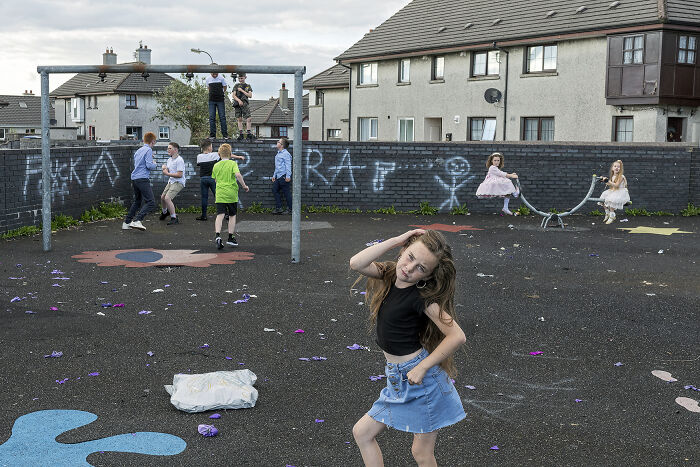 Children playing and posing creatively in a vibrant urban playground, showcasing unforgettable street photos of everyday life.