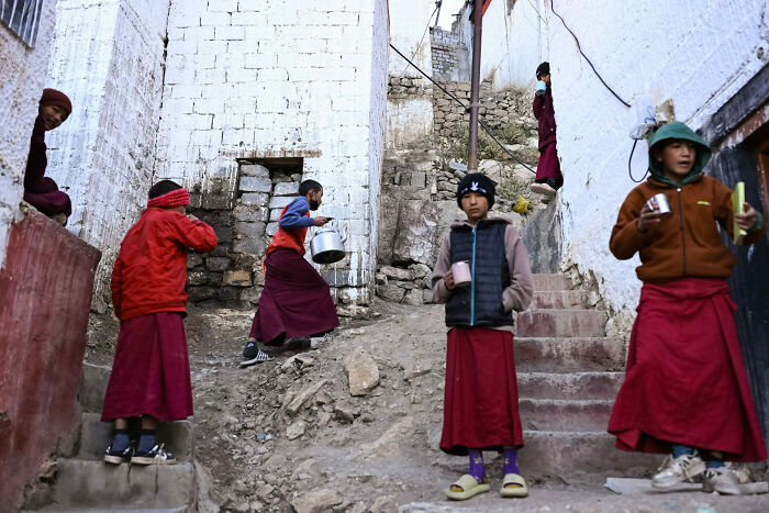 Children in traditional clothing captured in unforgettable street photos showing everyday life in a rustic setting.