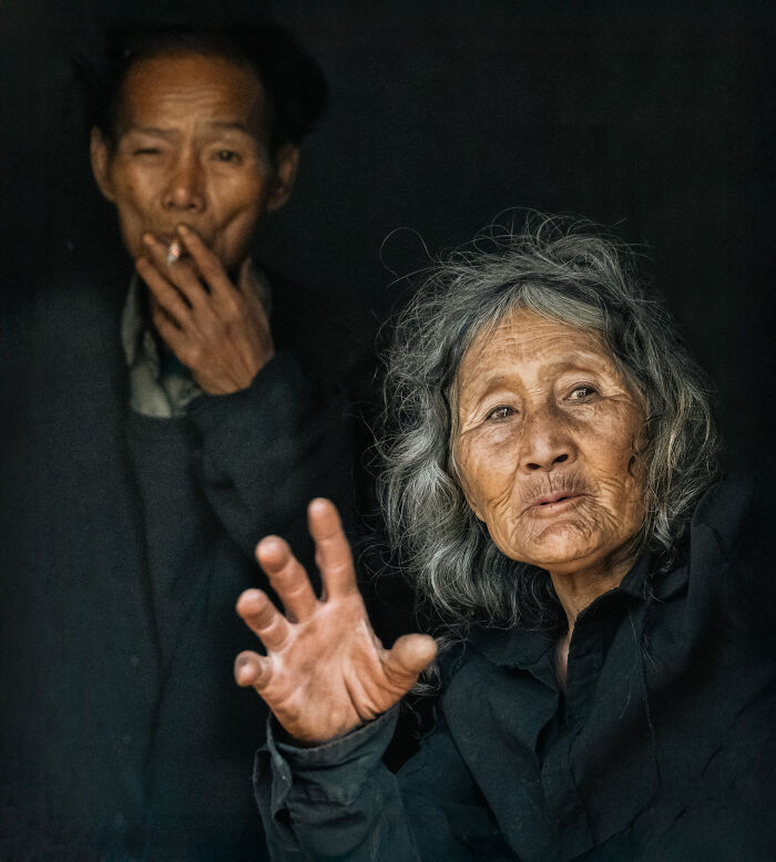 Elderly woman and man in traditional clothing, capturing the beauty of cultures through travel photography.