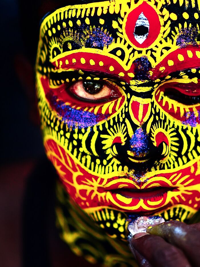 Close-up of vibrant Indian face paint with intricate patterns bursting with color and life, capturing vivid cultural expression.