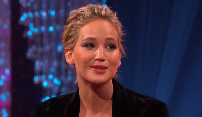 Celebrity woman with blonde hair wearing a black jacket, appearing out-of-touch while trying to be relatable on a talk show.