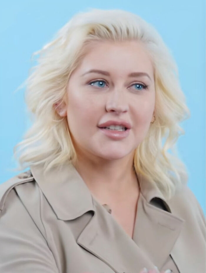 Christina Aguilera speaking in a beige coat against a blue background, related to Ozempic diet and overuse speculation. Christina Aguilera speaking in a beige coat against a blue background, related to Ozempic diet and overuse speculation.