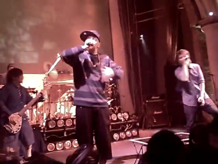 Live band performing on stage with singer and guitarist, captured in an intriguing video with unique context. - 9