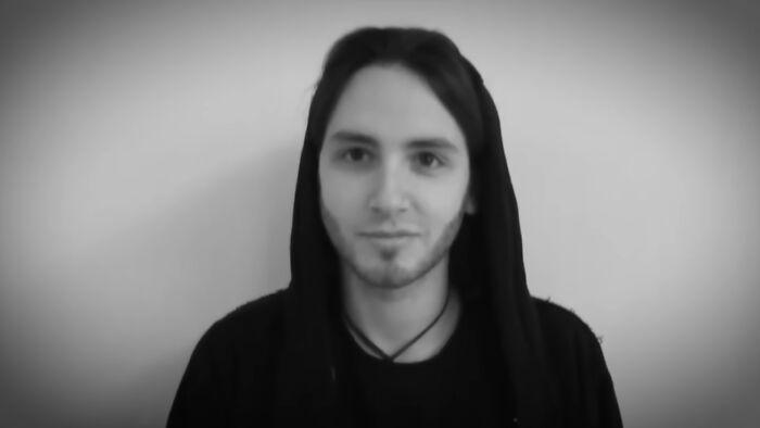 Young man in a black hoodie against a plain background, featured in videos that gain meaning with context. - 35