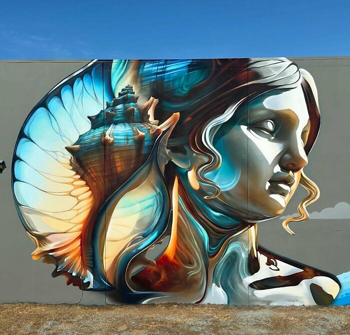 Mural blending graffiti, realism, and abstraction depicting a woman’s face with a seashell by Alexander Vizsla Bacon.