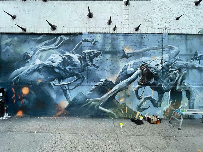 Mural by Alexander Vizsla Bacon featuring surreal, abstract creatures blending graffiti, realism, and abstraction on an urban wall.