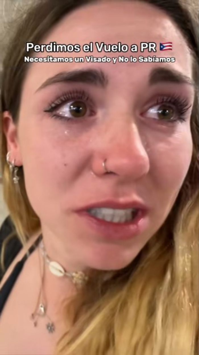 Tearful influencer close-up with a nose ring and necklace, blaming ChatGPT for missed flight and AI revenge claims.