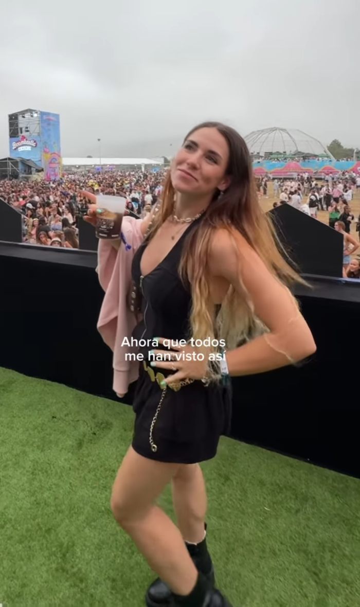 Young influencer at a crowded outdoor event, holding a drink and smiling, related to ChatGPT AI missed flight claims.