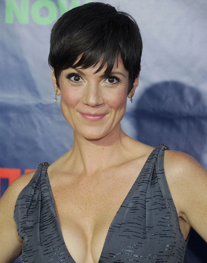 Woman with short dark hair wearing a gray dress at an event, related to celebrities and important figures disappearances.