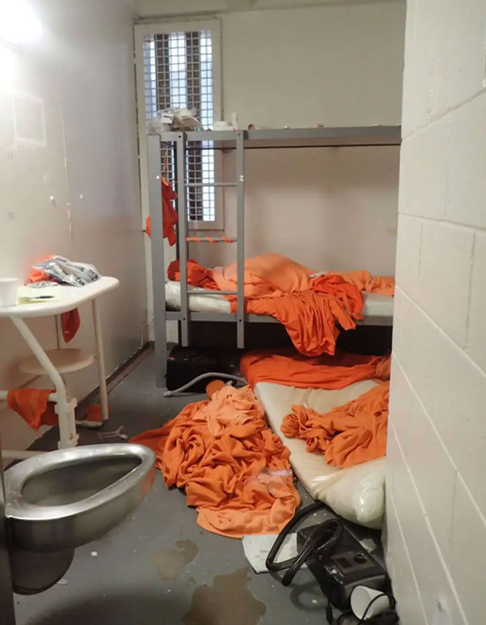 Messy jail cell with orange blankets and bunk beds highlighting Epstein jail video missing minutes controversy. - 7
