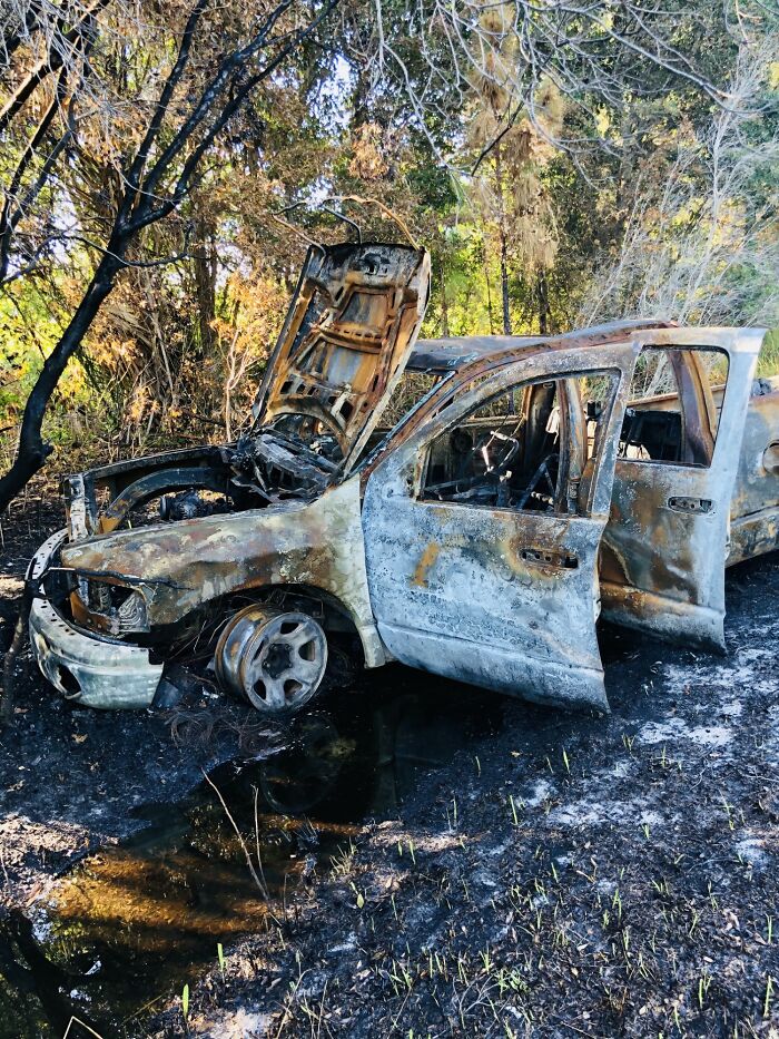Burned-out car wreckage abandoned in the woods, evoking fear and sleepless nights after time spent in nature. - 23