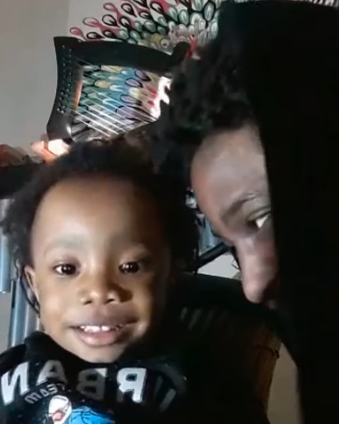 Young child smiling with adult close by, related to vegan diet and crucial signs ignored after toddler passed away.