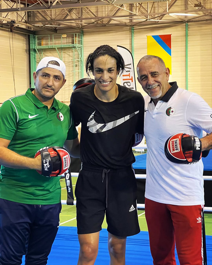 Imane Khelif with trainers in a gym, showcasing a dramatic makeover after Paris Olympics gender controversy.