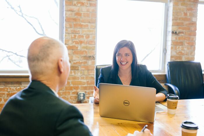 A woman conducting a job interview in a bright office, highlighting common job interview red flags in toxic workplaces.