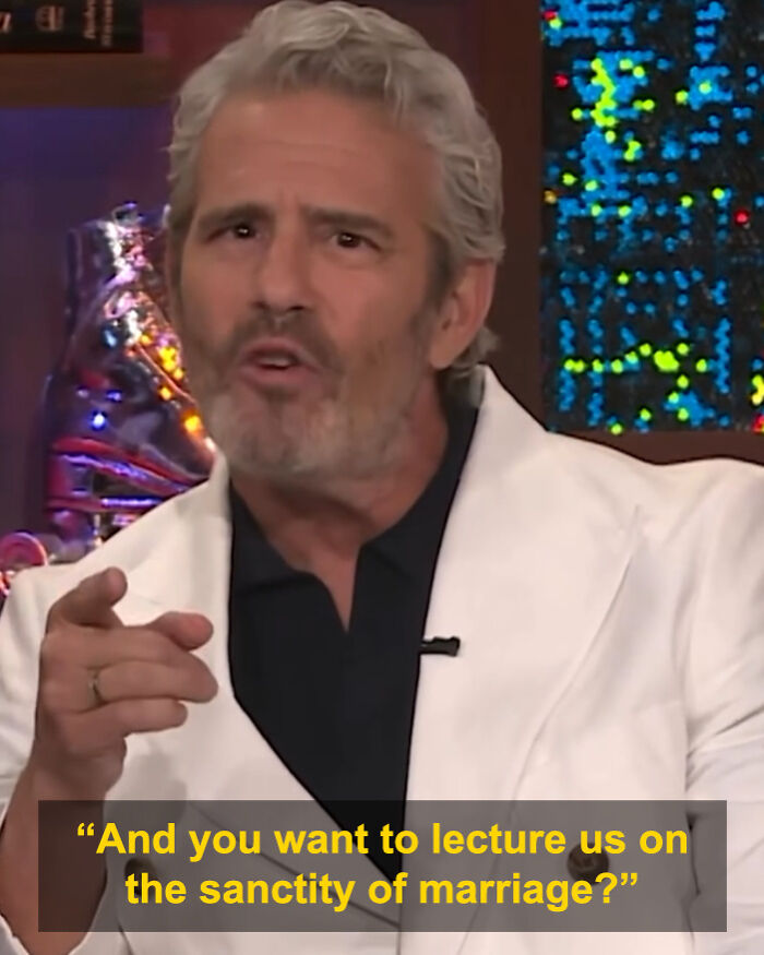 Andy Cohen pointing and speaking during a talk show, going viral for his roast of anti-LGBTQ activist Kim Davis.