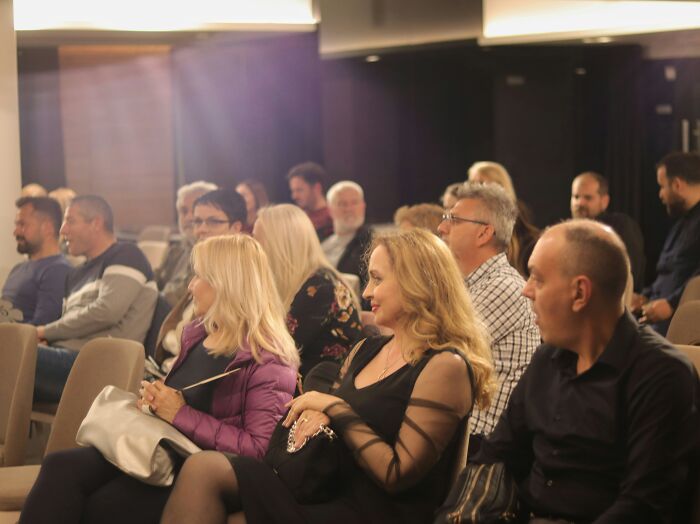 Audience listening attentively at an indoor event highlighting stories that put the wealth gap into perspective.